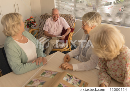 Group of senior people interacting with each other at nursing home 53000534