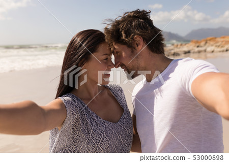 Romantic happy young couple head to head on beach Romantic happy young couple head to head on beach 53000898