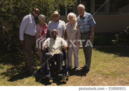 Front view of senior friends looking at camera in garden Front view of senior friends looking at camera in garden 53000931