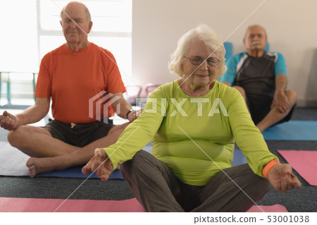 Senior people doing yoga in fitness studio Senior people doing yoga in fitness studio 53001038