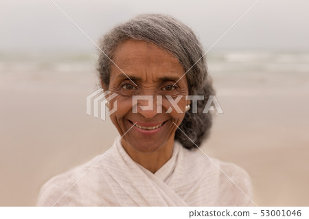 Senior woman looking at camera on the beach 53001046