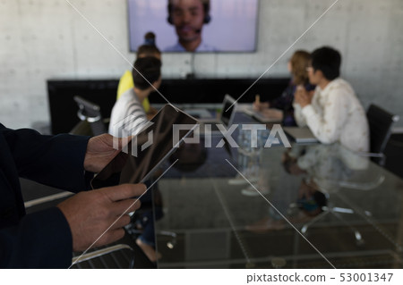 Businessman using digital tablet in office Businessman using digital tablet in office 53001347