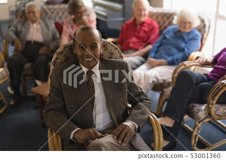 Front view of senior man looking at camera in nursing home Front view of senior man looking at camera in nursing home 53001360