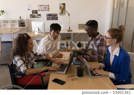 Business people interacting with each other in office Business people interacting with each other in office 53001361