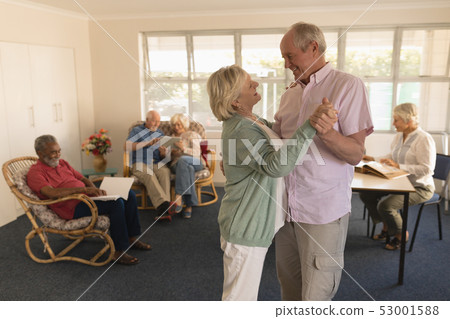 Active senior couple dancing at nursing home 53001588