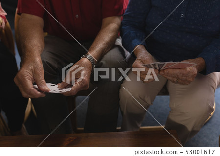 Senior men playing cards at home Senior men playing cards at home 53001617