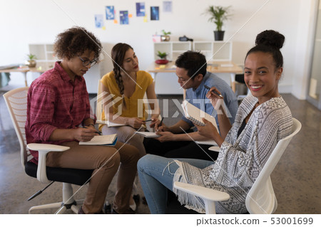Business colleagues interacting with each other in office 53001699