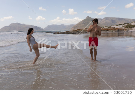 Happy young couple having fun at beach Happy young couple having fun at beach 53001730