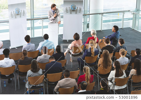 Male speaker with microphone speaks in a business seminar Male speaker with microphone speaks in a business seminar 53001896