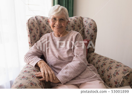 Front view of senior woman looking at camera in home 53001899