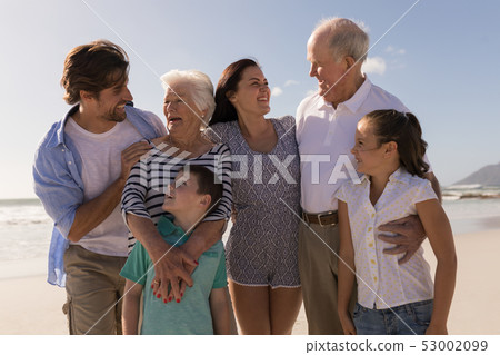 Family looking each other on beach Family looking each other on beach 53002099