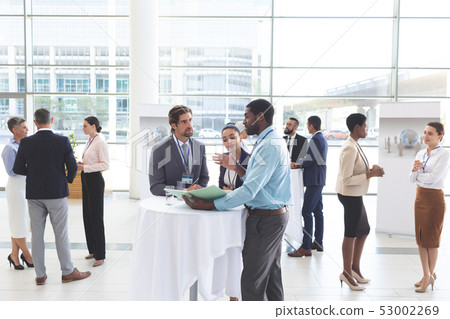 Business people discussing over documents at table during a seminar 53002269