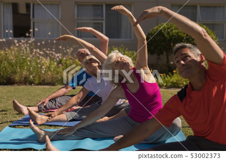 Trainer training senior people in performing exercise Trainer training senior people in performing exercise 53002373