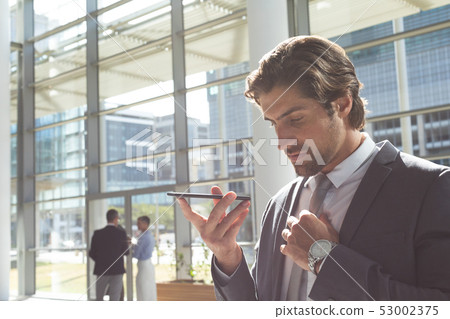 Businessman talking on mobile phone in lobby office Businessman talking on mobile phone in lobby office 53002375
