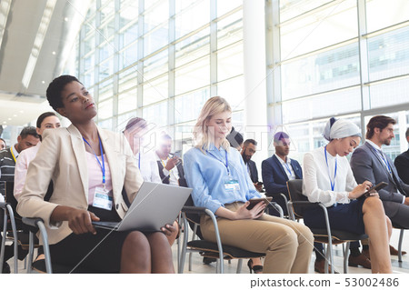 Business people attending a business seminar Business people attending a business seminar 53002486