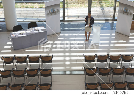 Businesswoman practising speech in empty conference room 53002693