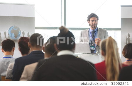 Male speaker with laptop speaks in a business seminar Male speaker with laptop speaks in a business seminar 53002841