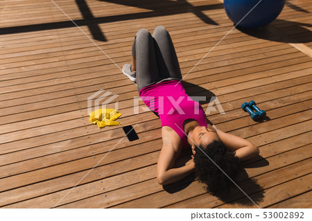 Woman relaxing in the backyard of home Woman relaxing in the backyard of home 53002892