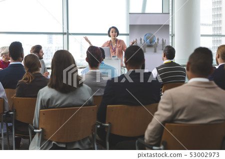 Female speaker with laptop speaks in a business seminar Female speaker with laptop speaks in a business seminar 53002973