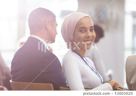 happy young businesswoman looking at camera during seminar 53003020