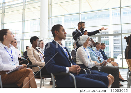 Businessman asking question during seminar 53003025
