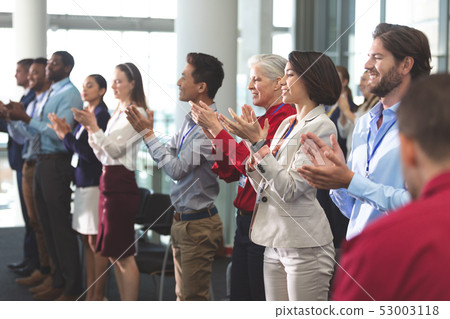 Happy business people applauding in a business seminar 53003118
