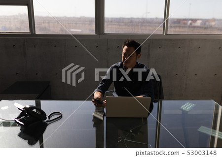 Businessman using mobile phone in the office 53003148