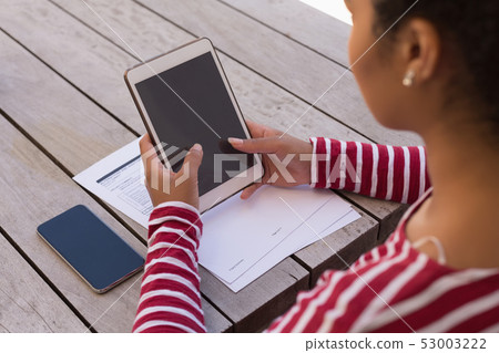 Woman using digital tablet at home Woman using digital tablet at home 53003222