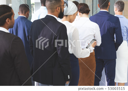 Business people checking in at conference registration table Business people checking in at conference registration table 53003515