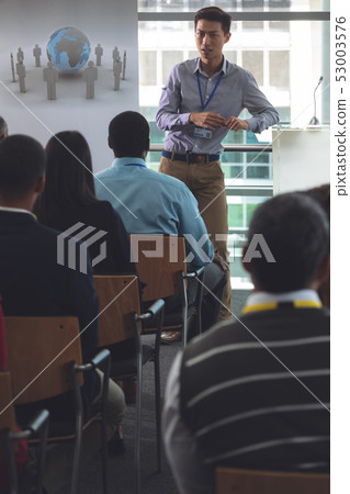 Young male speaker speaks in a business seminar Young male speaker speaks in a business seminar 53003576
