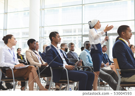 Businesswoman asking question during seminar Businesswoman asking question during seminar 53004593
