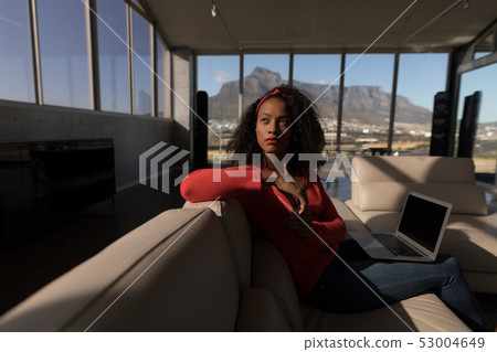 Female executive sitting with laptop in office Female executive sitting with laptop in office 53004649