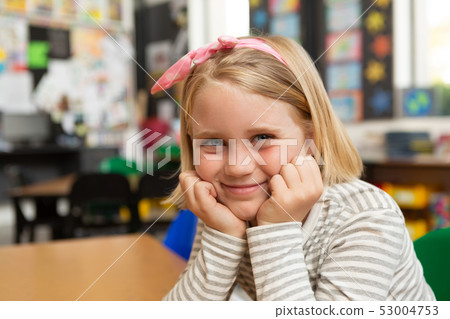 Schoolgirl sitting at desk in the classroom at school Schoolgirl sitting at desk in the classroom at school 53004753