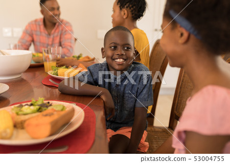 Siblings interacting with each other on dining table Siblings interacting with each other on dining table 53004755