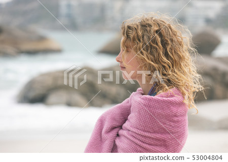 Woman standing on beach Woman standing on beach 53004804