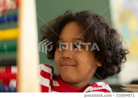 Boy learning mathematics with abacus in a classroom 53004971