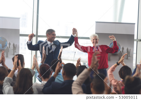 Business people applauding and celebrating in a business seminar 53005011