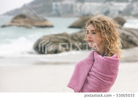 Woman standing on beach  53005035