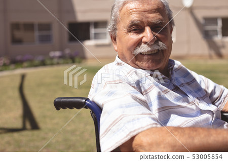 Senior man in wheelchair smiling at the camera Senior man in wheelchair smiling at the camera 53005854