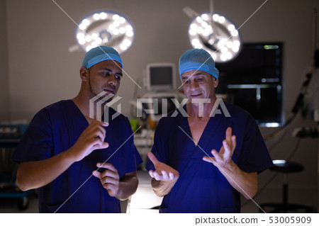 Surgeons interacting with each other in operation theater 53005909