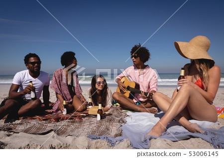 Happy group of friends having fun at beach in the sunshine 53006145