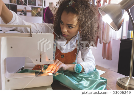 Female fashion designer working with sewing machine 53006249