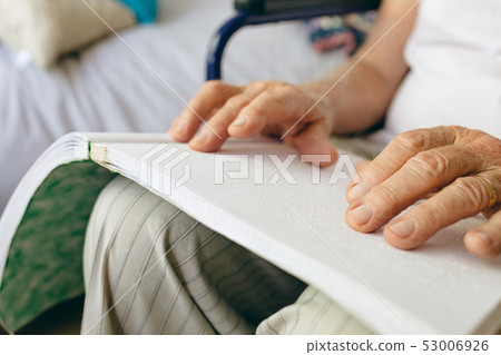 Senior male patient is reading in a retirement home Senior male patient is reading in a retirement home 53006926