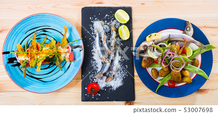 Set of dishes with small sea fish 53007698