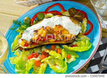 Delicious eggplant stuffed with vegetables and baked with cheese Delicious eggplant stuffed with vegetables and baked with cheese 53007840