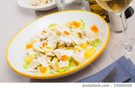 Dish with appetizing chicken salad, eggs and pineapples Dish with appetizing chicken salad, eggs and pineapples 53008508