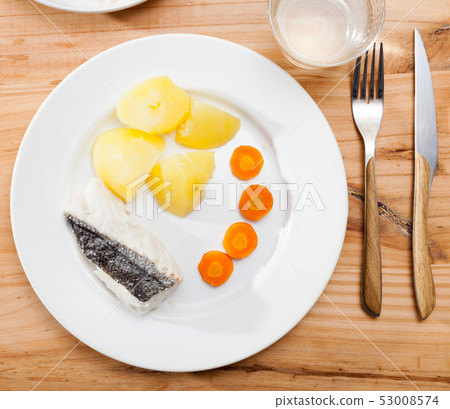 Top view of steamed hake with potatoes and carrot 53008574