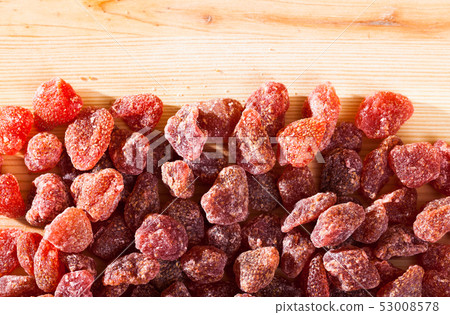 Dried red strawberry berries on wooden surface, nobody Dried red strawberry berries on wooden surface, nobody 53008578