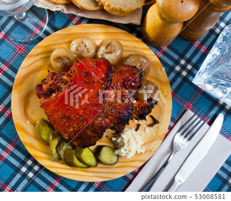 Appetizing pork knuckle served with boiled onions and pickled cucumbers Appetizing pork knuckle served with boiled onions and pickled cucumbers 53008581