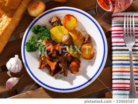 Top view of fried chanterelles with potatoes, chicken hearts Top view of fried chanterelles with potatoes, chicken hearts 53008587